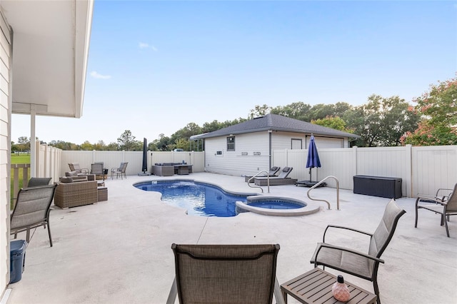 view of pool with an in ground hot tub and a patio area