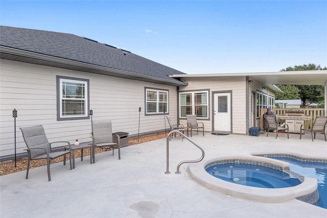 view of pool featuring a patio and an in ground hot tub