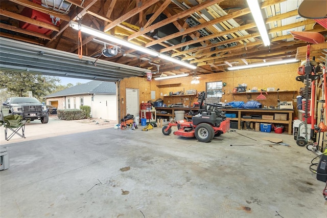 garage with a garage door opener and a workshop area