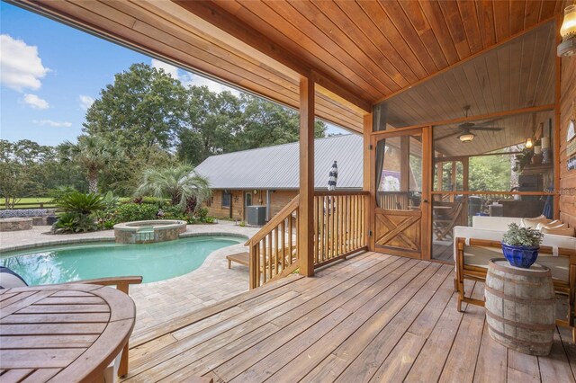 wooden deck with a pool with hot tub, central AC, and ceiling fan