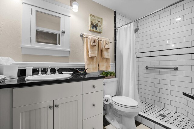 bathroom with vanity, curtained shower, and toilet