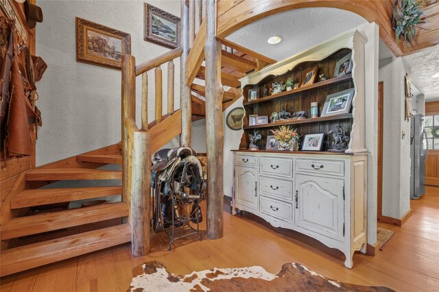 stairs featuring hardwood / wood-style flooring