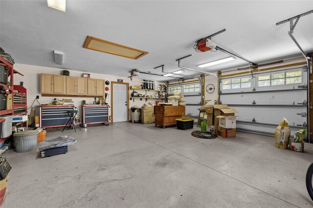 garage featuring a garage door opener and a workshop area