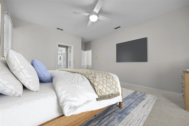 carpeted bedroom with baseboards, visible vents, and a ceiling fan