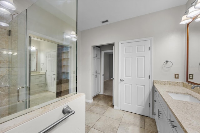 bathroom featuring a stall shower, tile patterned floors, visible vents, and vanity