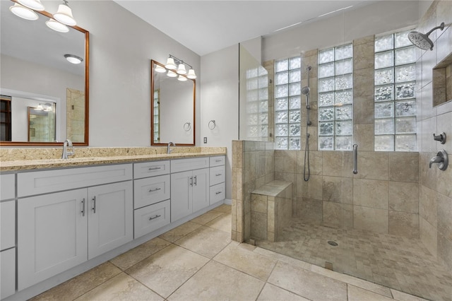 bathroom featuring a sink, double vanity, and a shower stall