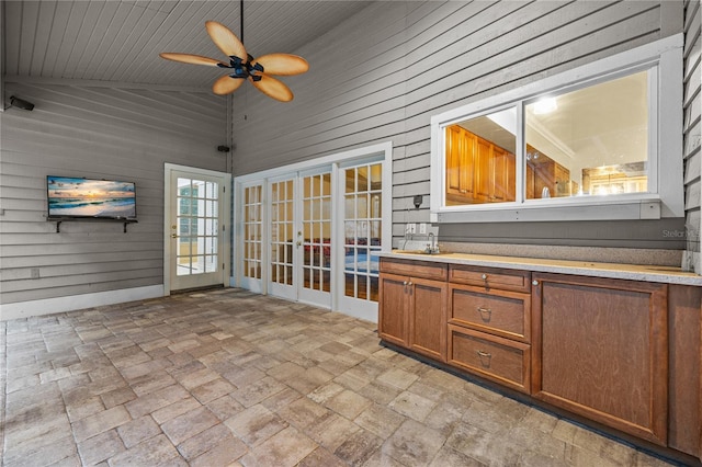 interior space featuring ceiling fan, vaulted ceiling, a sink, and french doors