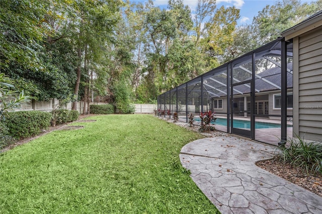 view of yard featuring a patio, a fenced backyard, a fenced in pool, and a lanai