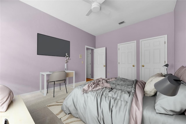 carpeted bedroom with ceiling fan, visible vents, and baseboards