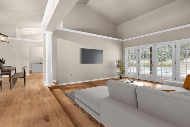 living area with light wood finished floors, baseboards, french doors, ornate columns, and high vaulted ceiling