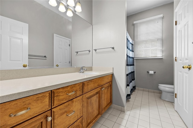 full bathroom with toilet, a notable chandelier, vanity, baseboards, and tile patterned floors