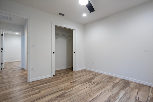 unfurnished bedroom with ceiling fan, light hardwood / wood-style flooring, and a closet