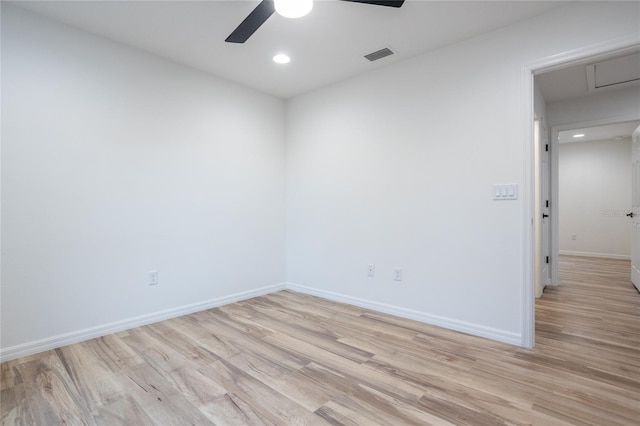 spare room with light wood-type flooring and ceiling fan