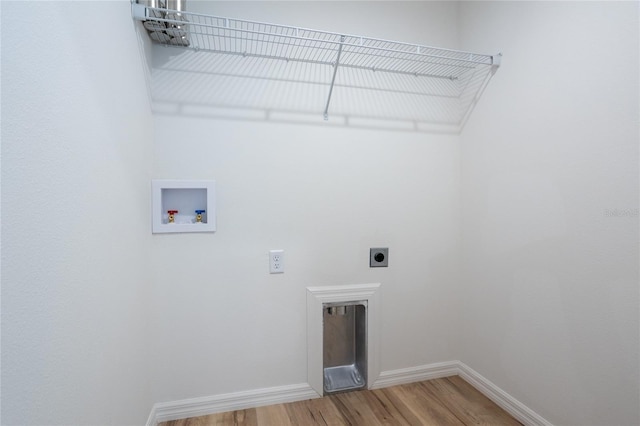 clothes washing area featuring hookup for an electric dryer, wood-type flooring, and washer hookup