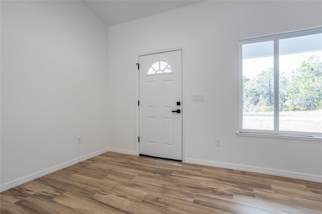 entryway with light wood finished floors and baseboards