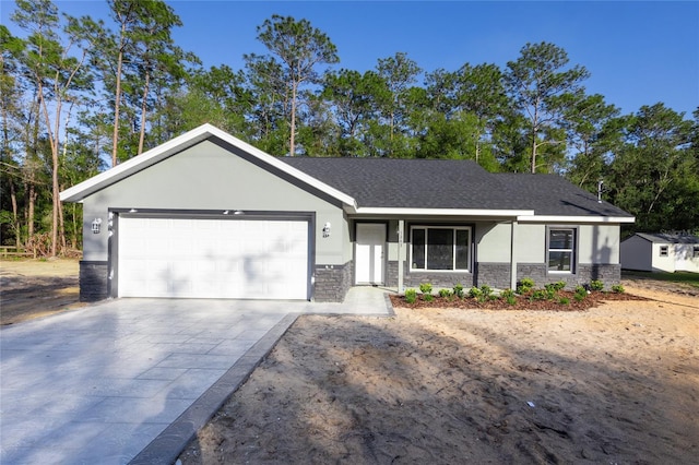 ranch-style house with driveway, a shingled roof, stucco siding, stone siding, and a garage