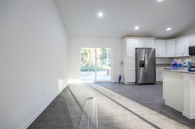 1243 NE 130th Ter, Silver Springs, FL 34488 - kitchen with appliances with stainless steel finishes, vaulted ceiling, white cabinetry, recessed lighting, and light stone counters