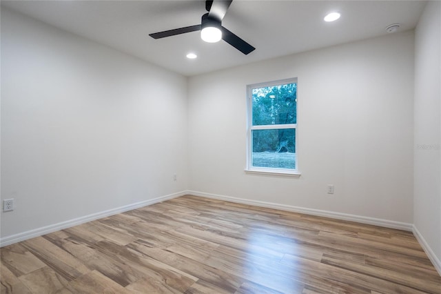 spare room featuring ceiling fan and light hardwood / wood-style flooring