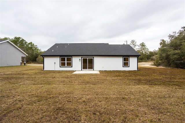 rear view of house with a patio area and a lawn