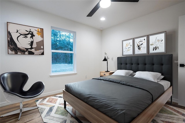 bedroom with hardwood / wood-style floors and ceiling fan