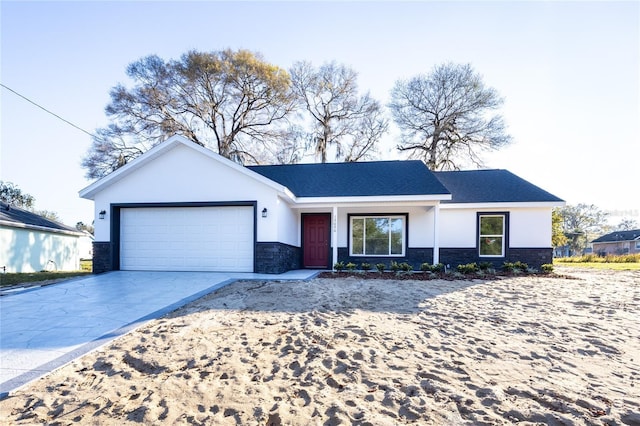 ranch-style home featuring a garage, driveway, stone siding, and stucco siding