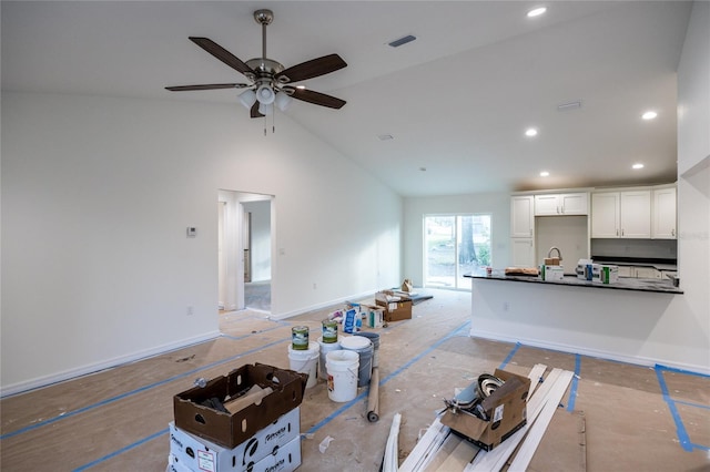 living area featuring high vaulted ceiling, baseboards, visible vents, and recessed lighting