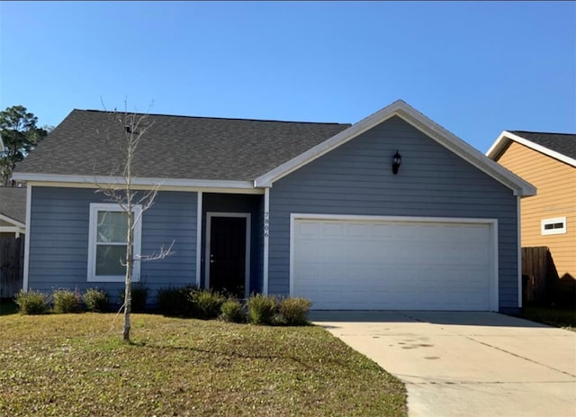 single story home with a garage and a front lawn