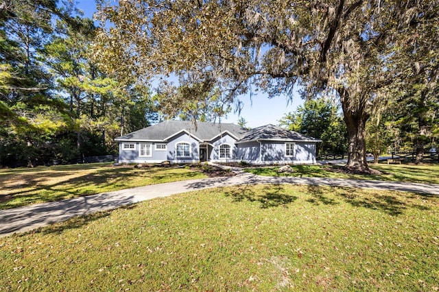 ranch-style house with a front lawn