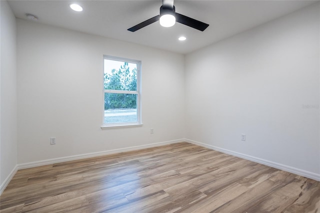 unfurnished room with light wood-type flooring and ceiling fan