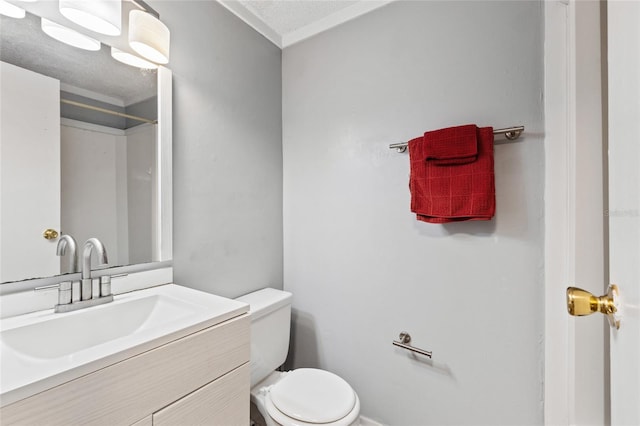 bathroom with vanity, a textured ceiling, and toilet