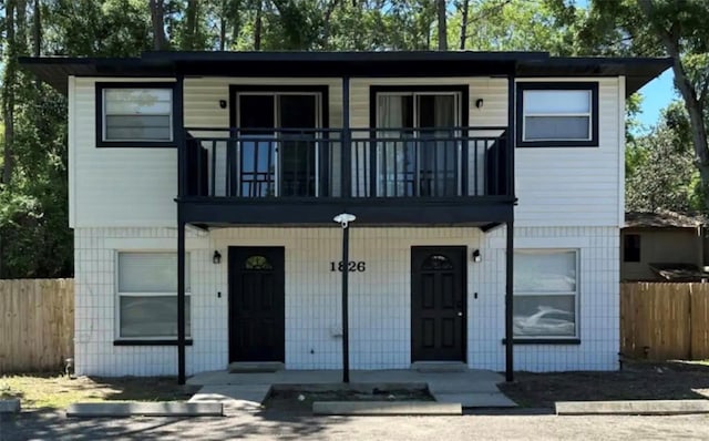 view of front of property with a porch and a balcony