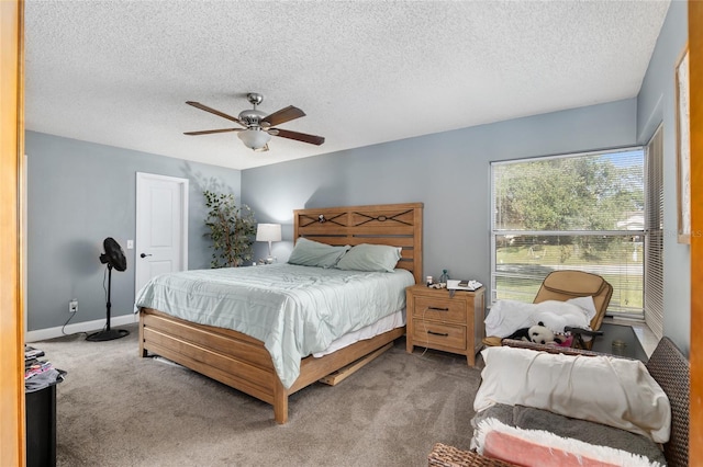 carpeted bedroom with ceiling fan and a textured ceiling