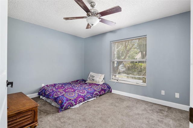 carpeted bedroom featuring a textured ceiling and ceiling fan