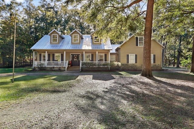 cape cod-style house featuring covered porch