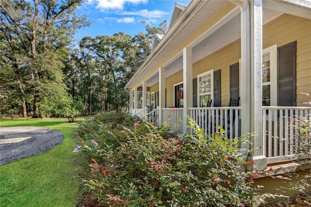 view of property exterior featuring a lawn and covered porch