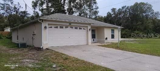 exterior space with central AC and a yard