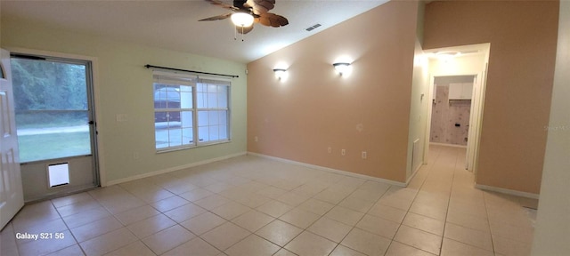 tiled spare room featuring ceiling fan and vaulted ceiling