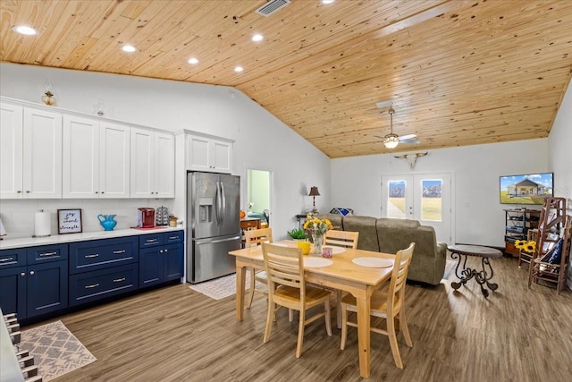 dining room with french doors, wood ceiling, hardwood / wood-style floors, high vaulted ceiling, and ceiling fan