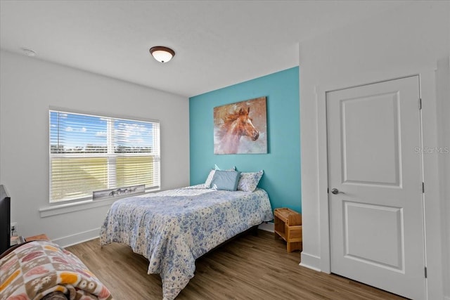 bedroom with hardwood / wood-style floors