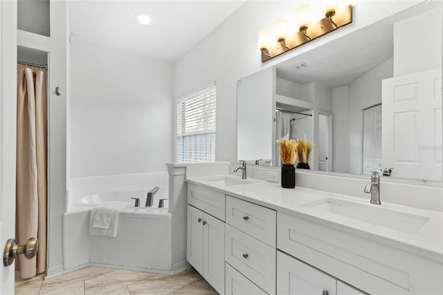 bathroom with a sink, visible vents, a bath, and double vanity