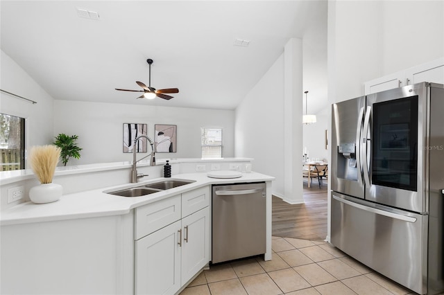 kitchen featuring visible vents, light countertops, light tile patterned floors, appliances with stainless steel finishes, and a sink