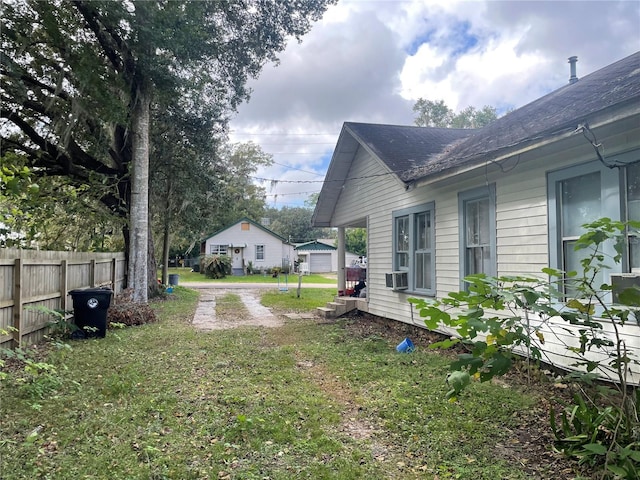 view of yard featuring a garage and cooling unit