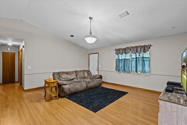 living room with hardwood / wood-style floors and vaulted ceiling