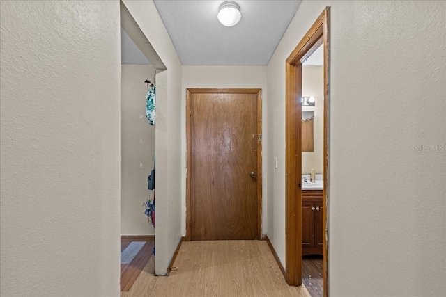 hall with light hardwood / wood-style floors