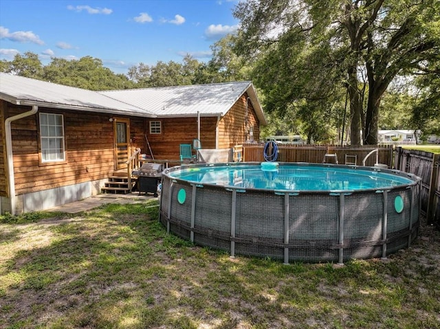 view of swimming pool with fence and a fenced in pool