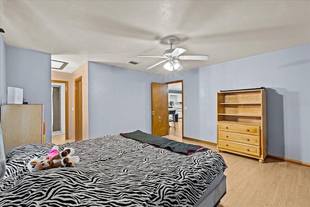 bedroom with light wood-style floors, baseboards, visible vents, and ceiling fan