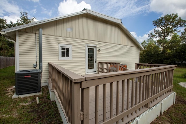 rear view of property featuring a deck and central AC unit