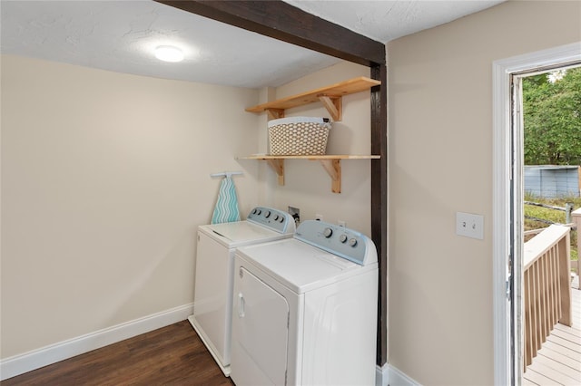 washroom with washer and dryer, a textured ceiling, and dark hardwood / wood-style flooring