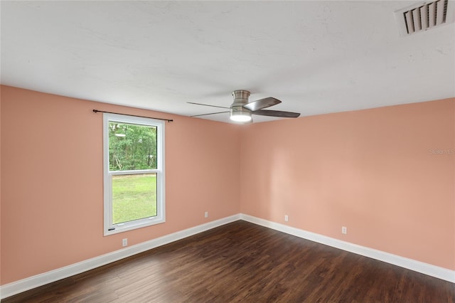 spare room featuring dark hardwood / wood-style floors and ceiling fan