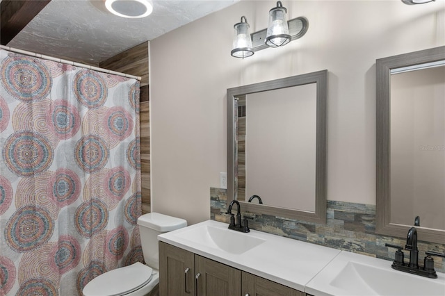 bathroom with curtained shower, backsplash, a textured ceiling, toilet, and vanity